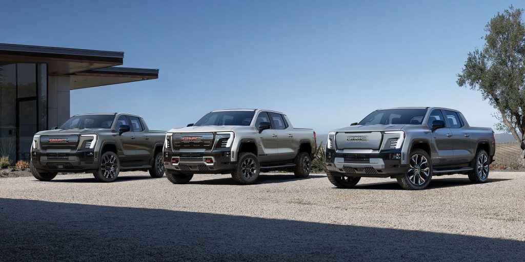 A line-up of three GMC trucks showcasing different models and designs.