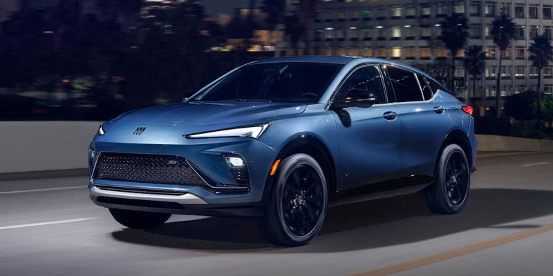 2025 Buick Envista in motion on a city street at night.