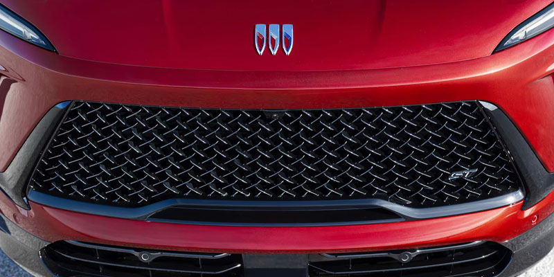 Front view close-up of a red Buick vehicle grille and emblem.